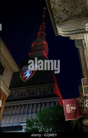 On 4 may, the 67 anniversary of the Superga air disaster, where players of the 'Grande Torino' lost their lives in a plane crash, the symbol of Turin, the Mole Antonelliana is lighted with red-Garnet and the main façade is projected the team's symbol (Photo by: Daniela Parra Saiani/Pacific Press) Stock Photo