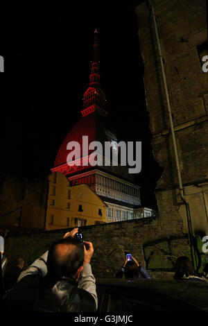 On 4 may, the 67 anniversary of the Superga air disaster, where players of the 'Grande Torino' lost their lives in a plane crash, the symbol of Turin, the Mole Antonelliana is lighted with red-Garnet and the main façade is projected the team's symbol (Photo by: Daniela Parra Saiani/Pacific Press) Stock Photo