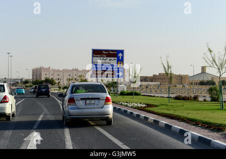 QATAR, Doha, road and parking place at religious complex with christian churches for migrant workers, right catholic church Stock Photo