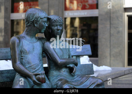 The sculpture of the Secret Bench of Knowledge by Sculptor Iea Vivot on sidewalk of Ave McGill College,Montreal,Quebec,Canada Stock Photo