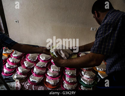 Beit Lahiya, Gaza. 10th Apr, 2016. Palestinians prepare food during a ...