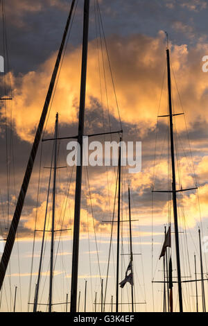 Sailboat masts silhouetted against sunset Stock Photo - Alamy