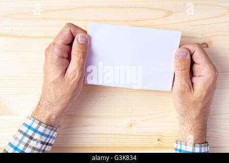 Man holding blank brochure as mock up copy space for graphic design or text placement Stock Photo