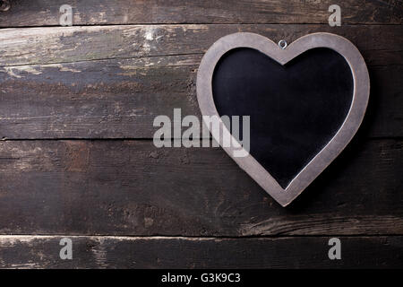 Wooden heart with blackboard on old brown wooden background Stock Photo