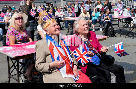 People celebrating Queen Elizabeth's 90th birthday celebrations in Trafalgar Square in London Stock Photo
