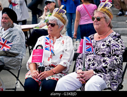 People celebrating Queen Elizabeth's 90th birthday celebrations in Trafalgar Square in London Stock Photo