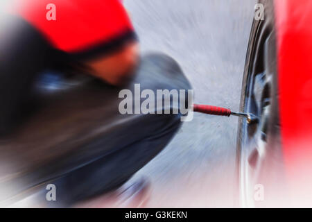 Blur man inflate tires in the garage. Stock Photo
