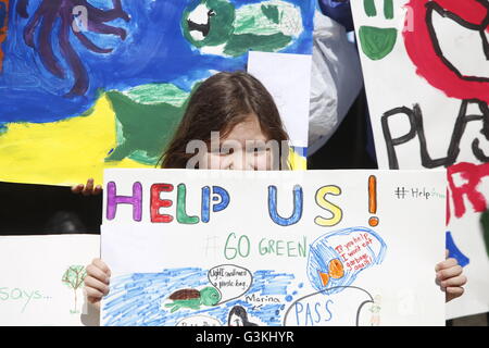 New York City, United States. 13th Apr, 2016. Walt Whitman middle school student with hand-lettered sign. Activist Rolando Guzman from Outrage speaks. NYC middle & high school students joined members of the NYC city council on city hall steps to call for implementation of a proposed ban on the use of plastic bags in retail environments & for substitution of reusable cloth bags in their place © Andy Katz/Pacific Press/Alamy Live News Stock Photo