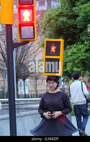 The artist Kubra Khademi (Ghor, Afghanistan, 1989) toured the streets of Gijon semaphore disguised for a performance titled 'Kubra and crosswalks III' with the aim of combating machismo. On her head she wore an orange box, simulating a traffic light with two loops, including two bulbs, one green and one red, and on them two black cardboard with holes in the shape of a woman. A woman with dress to criticize the machismo that is behind a semaphore for using figures pants. 'It 's a reflection regarding the signs and names of everyday life, ' said Khademi to present its activity, which stunned p Stock Photo