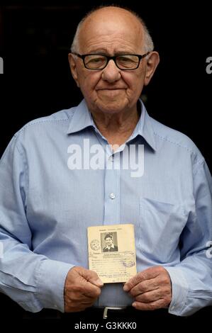 Previously unissued photo dated 25/5/2016 of Holocaust survivor Zigi Shipper holds his entry passport from 1946 at his home in Bushey, Hertfordshire. The 86 year old who has spent his retirement sharing harrowing wartime experiences with British schoolchildren is to feature in a &quot;time capsule&quot; documentary designed to ensure the horrors of Auschwitz are never forgotten. Stock Photo