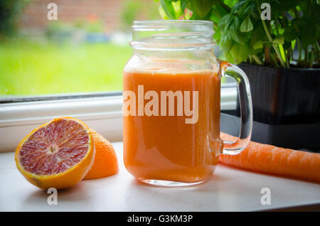 orange and carrot juice, healthy juicing Stock Photo