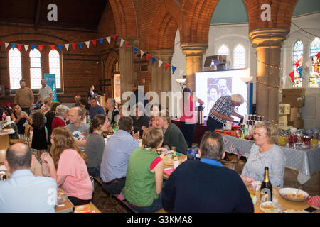 Rain meant 'The Big lunch' moved inside church. Residents eating food in church, dining, community Stock Photo