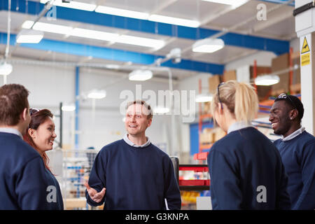 Manager explaining to team in manufacturing factory Stock Photo