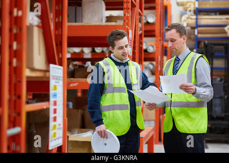 Manager training factory worker in factory warehouse Stock Photo