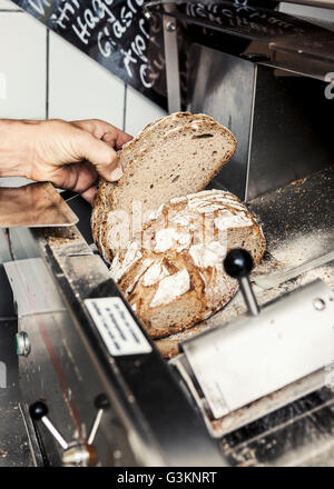 Baker with loaf of sliced bread Stock Photo