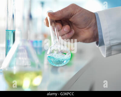 Scientist preparing a chemical formula in a conical flask during an experiment in the laboratory Stock Photo