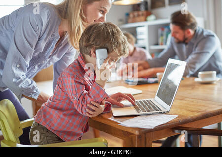Parents and sons working in home office Stock Photo