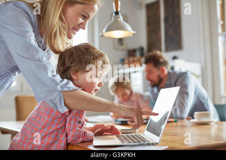 Parents and sons working in home office Stock Photo