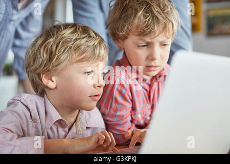 Boys using laptop Stock Photo