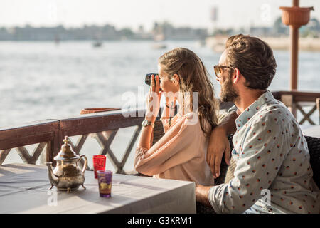 Romantic couple photographing from Dubai marina cafe, United Arab Emirates Stock Photo