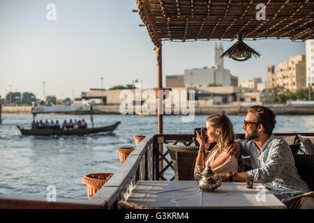 Romantic couple photographing from Dubai marina cafe, United Arab Emirates Stock Photo