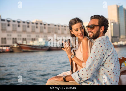 Romantic couple photographing on boat at Dubai marina, United Arab Emirates Stock Photo