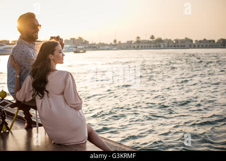 Romantic couple looking out from boat at Dubai marina, United Arab Emirates Stock Photo