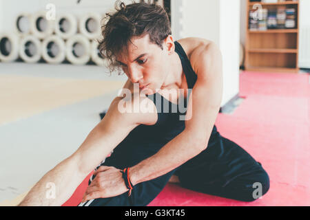 Man doing leg stretching exercise Stock Photo