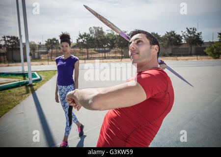 Young male javelin thrower practicing at sports ground Stock Photo