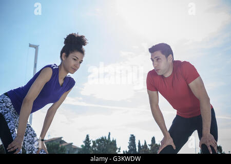 Young man and woman training, taking a break at sport facility Stock Photo