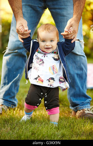 Baby girl taking her first steps Stock Photo - Alamy