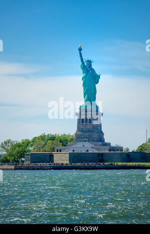 The Statue of Liberty as seen from the Staten Island Ferry crossing New York Harbor Stock Photo