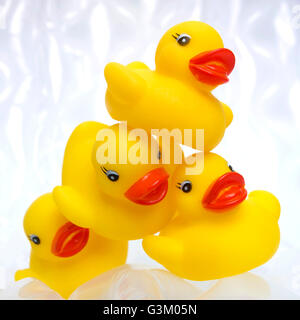 Four yellow rubber ducks on a white background Stock Photo - Alamy
