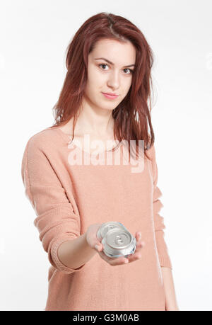 Young woman holding crushed drink cans Stock Photo