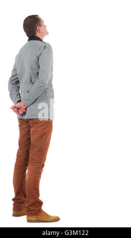 Back view of stylishly dressed man in a brown jackett looking up. Standing young guy in jeans and jacket. Rear view people collection. backside view of person. Isolated over white background. Stock Photo