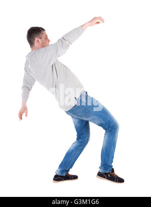 Back view man Balances waving his arms. Rear view people collection. backside view of person. Isolated over white background. slipping man Stock Photo