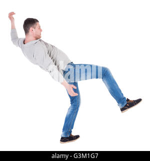 Back view man Balances waving his arms. Rear view people collection. backside view of person. Isolated over white background. the falling man balancing on one leg. Stock Photo