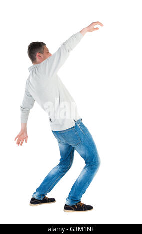 Back view man Balances waving his arms. Rear view people collection. backside view of person. Isolated over white background. A guy in a gray jacket at the time of the fall. Stock Photo