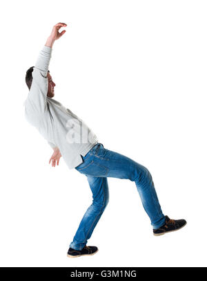 Back view man Balances waving his arms. Rear view people collection. backside view of person. Isolated over white background. A guy in a gray jacket slipped Stock Photo