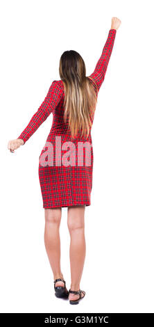 Back view of woman. Raised his fist up in victory sign. Rear view people collection. backside view of person. Isolated over white background.Long-haired girl in a red plaid dress is raising a fist above his head.