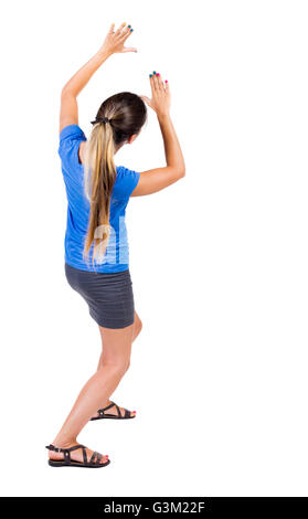 back view of woman protects hands from what is falling from above. Man holding a heavy load Rear view people collection. backside view of person. Isolated over white background. Girl in a gray skirt and blue shirt covered his hands on top of something fal