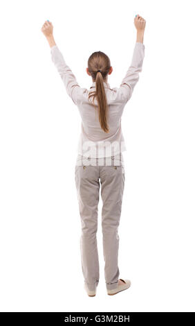 Back view of business woman. Raised his fist up in victory sign. Raised his fist up in victory sign. Rear view people collection. backside view of person. Isolated over white background. Girl with long hair in a white jacket is raising his fists above his Stock Photo