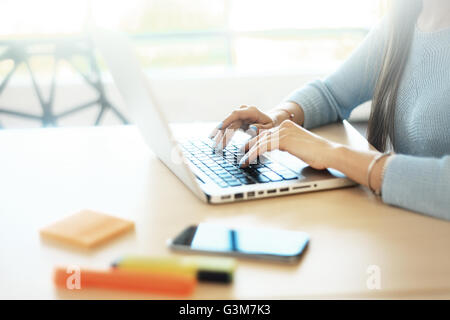 Young man working with laptop, man hands on notebook computer, business person at workplace Stock Photo