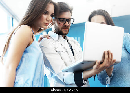 Project manager team discussing new idea.Business crew working with startup. Laptop, showing presentation, monitor.Blurred,film effect. Stock Photo