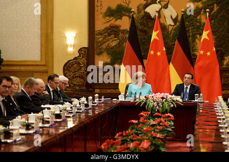 German Chancellor Angela Merkel (CDU) and Chinese Premier Li Keqiang (both at the head of the table) attend a meeting at the Great Hall of the People in Beijing, China, 13 June 2016. Further more the meeting is attended by German Minister of Economic Cooperation and Development, Gerd Mueller (L-R, CSU), German Minister for Education and Research, Johanna Wanka (CDU), German Minister of Health, Hermann Groehe (CDU), German Finance Minister Wolfgang Schaeuble (CDU), German Justice Minister Heiko Maas (SPD) and German Minister for Foreign Affairs, Frank-Walter Steinmeier (SPD). The German Chanc Stock Photo