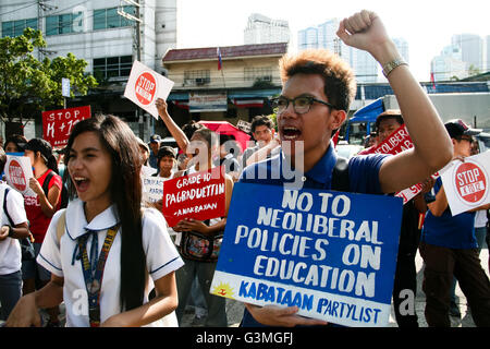 June 13, 2016 - Philippines - Students raise their fists as they march to the Department of Education office in Pasig City to denounce the implementation of the K to 12 program. According to the student protesters, the added years in the education program caused the drop outs of thousands of students who canâ€™t afford another year of school expenses. (Credit Image: © J Gerard Seguia via ZUMA Wire) Stock Photo