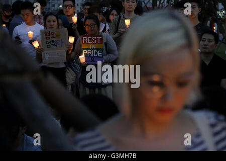 Seoul, South Korea. 13th June, 2016. People hold candles during a vigil to pay tribute to the victims of yesterday's Orlando shooting in Seoul, South Korea. The vigil was held for victims of the Orlando nightclub shooting which killed at least 50 people and was the deadliest U.S. mass shooting to date. Credit:  Seung Il Ryu/ZUMA Wire/Alamy Live News Stock Photo