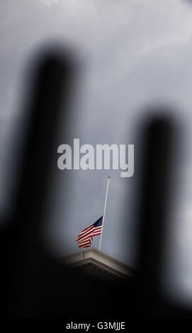 Hamburg, Germany. 13th June, 2016. The US national flag flies at half-mast for the victims of a mass shooting in Orlando, USA on 12 June, at the US Consulate in Hamburg, Germany, 13 June 2016. A total of 50 people inculding the suspect were killed and 53 were injured in a shooting attack at an LGBT club in Orlando, Florida, in the early hours of 12 June. The shooter, Omar Mateen, 29, a US citizen of Afghan descent, was killed in an exchange of fire with the police after taking hostages at the club. Photo: Lukas Schulze/dpa/Alamy Live News Stock Photo