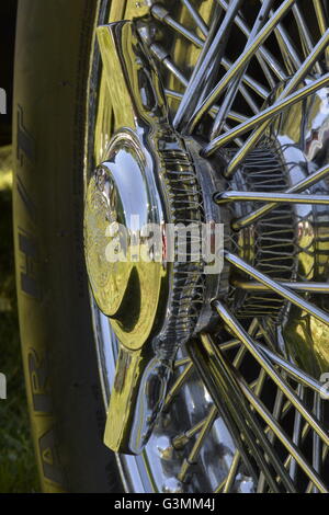 Westbury, New York, USA. June 12, 2016. Rudge-Whitworth, Milano, 52mm 72 spoke chrome wire wheel with 2-bar spinner (AKA knock off), with Destro Smontare printed, is seen in close up on 1973 Intermeccanica Squire SS-100 Italian luxury classic roadster, owned by Mark Offenberg of Valley Stream, which won 3rd Place Trophy in the foreign car category at the Antique and Collectible Auto Show at the 50th Annual Spring Meet at Old Westbury Gardens, in the Gold Coast of Long Island, and sponsored by Greater New York Region, GNYR, Antique Automobile Club of America, AACA. Stock Photo