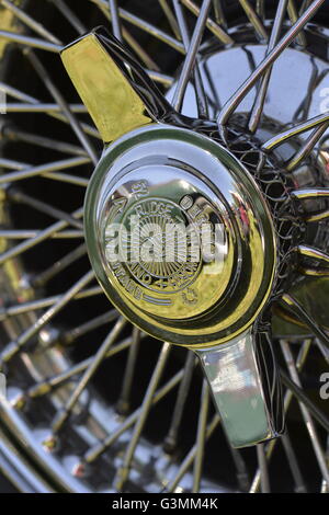 Westbury, New York, USA. June 12, 2016. Rudge-Whitworth, Milano, 52mm 72 spoke chrome wire wheel with 2-bar spinner (AKA knock off), with Destro Smontare printed, is seen in close up on 1973 Intermeccanica Squire SS-100 Italian luxury classic roadster, owned by Mark Offenberg of Valley Stream, which won 3rd Place Trophy in the foreign car category at the Antique and Collectible Auto Show at the 50th Annual Spring Meet at Old Westbury Gardens, in the Gold Coast of Long Island, and sponsored by Greater New York Region, GNYR, Antique Automobile Club of America, AACA. Stock Photo